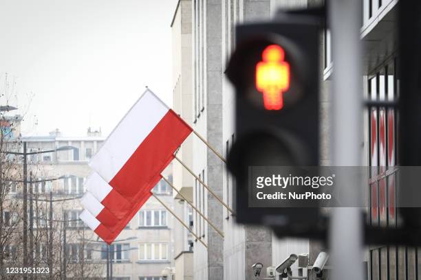 Polish flags are seen hanging from the Polish National Bank in Warsaw, Poland on March 26, 2021. The Polish government on Thursday announced further...