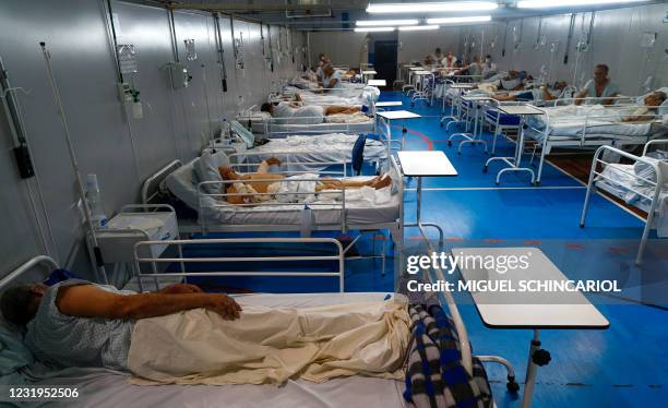 Patients affected by the COVID-19 coronavirus remain at a field hospital set up at a sports gym, in Santo Andre, Sao Paulo state, Brazil, on March...