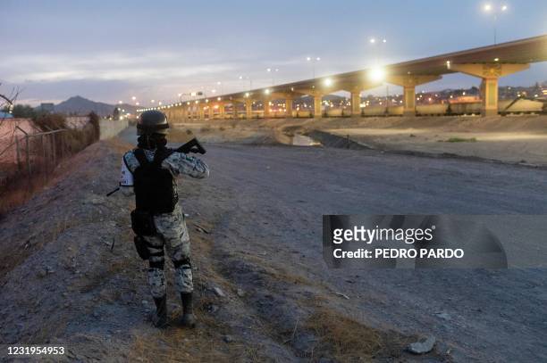 An officer of the Mexican National Guard patrols along the Rio Bravo in Ciudad Juarez, in the Mexican state of Chihuahua, across the border with El...