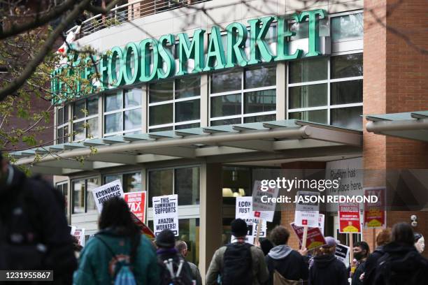 People rally rally outside a Whole Foods Market after marking from Amazon headquarters in solidarity with Amazon workers in Bessemer, Alabama, who...