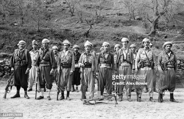 Kurdish Peshmerga fighters sing a patriotic song while on parade in a hidden military camp in the Zagros Mountains of northern Iraq, 10th May 1979.