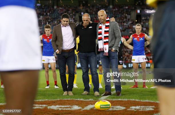 Garry Lyon, Tony Lockett and Stewart Loewe pause to remember Danny Frawley during the 2021 AFL Round 02 match between the St Kilda Saints and the...