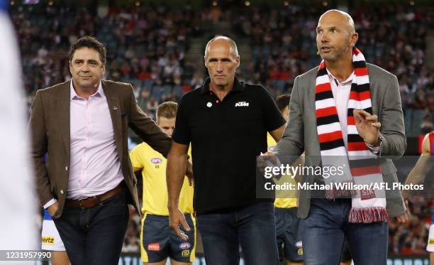 Garry Lyon, Tony Lockett and Stewart Loewe pause to remember Danny Frawley during the 2021 AFL Round 02 match between the St Kilda Saints and the...