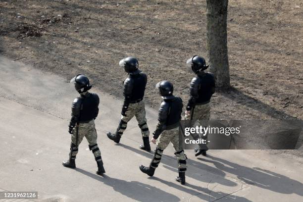 Belarus law enforcement officers patrol the street at a planned rally after protesters were prevented from doing so by police, who cordoned off...