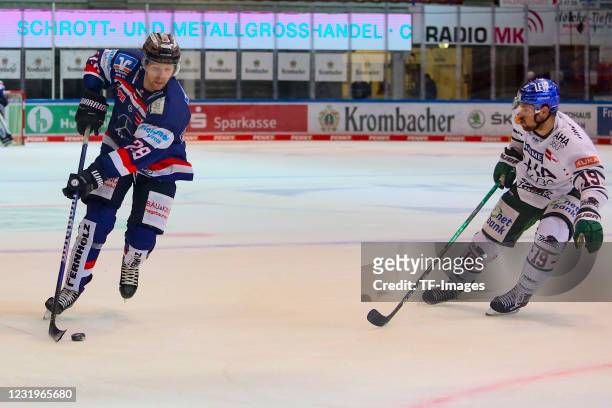 Griffin Reinhart of Iserlohn Roosters and Drew LeBlanc of Augsburger Panther controls the puck during the DEL match between Iserlohn Roosters and...