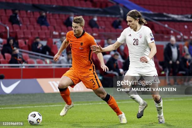 Dutch center-back Matthijs de Ligt fights for the ball againsy Latvia's forward Roberts Uldrikis during their World Cup qualifying Group G match...