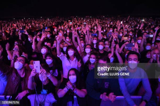 Spectators wait for the start of a rock music concert by Spanish group Love of Lesbian at the Palau Sant Jordi in Barcelona on March 27, 2021. -...