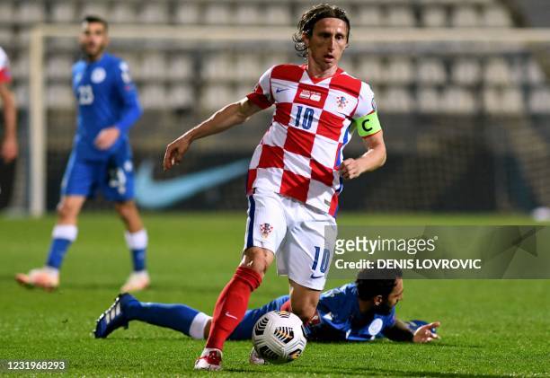Croatia's midfielder Luka Modric runs with the ball during the FIFA World Cup Qatar 2022 qualification Group H football match between Croatia and...