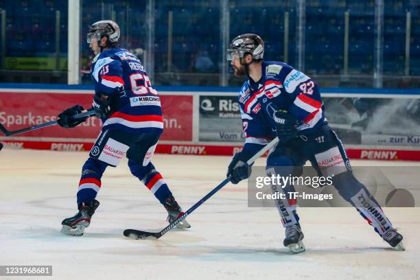 Philip Riefers of Iserlohn Roosters and Alexandre Grenier of Iserlohn Roosters controls the puck during the DEL match between Iserlohn Roosters and...