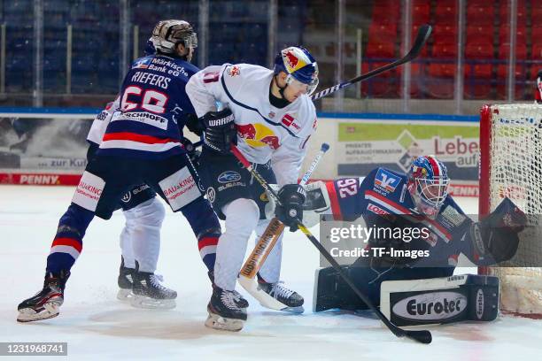 Philip Riefers of Iserlohn Roosters, Andreas Jenike of Iserlohn Roosters and Philip Gogulla of EHC Red Bull Muenchen with a chance to score during...