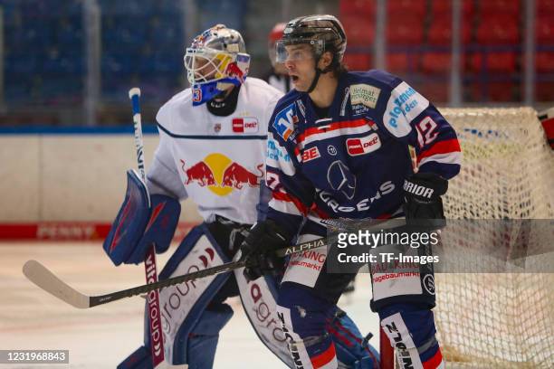 Steve Whitney of Iserlohn Roosters and Danny aus den Birken of EHC Red Bull Muenchen controls the puck during the DEL match between Iserlohn Roosters...
