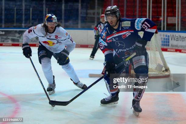 Brody Sutter of Iserlohn Roosters and Konrad Abeltshauser of EHC Red Bull Muenchen controls the puck during the DEL match between Iserlohn Roosters...