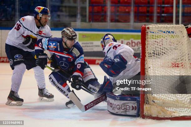 Andrew Ebbett of EHC Red Bull Muenchen, Brent Raedeke of Iserlohn Roosters and Danny aus den Birken of EHC Red Bull Muenchen with a chance to score...