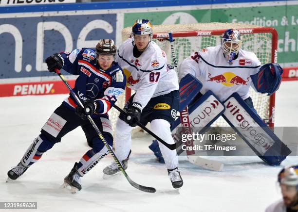 Marko Friedrich of Iserlohn Roosters, Philip Gogulla of Red Bull Muenchen and goalkeeper Danny aus den Birken of Red Bull Muenchen battle for the...