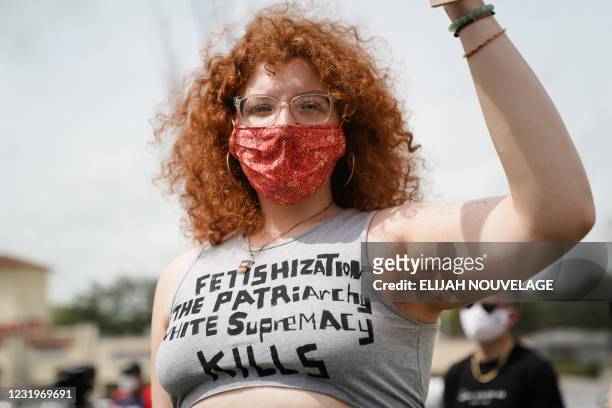 Liz Elliott wears a shirt denouncing white supremacy while participating in an 'Anti Asian Hate' rally on March 27 in Chamblee, Georgia. - The rally...