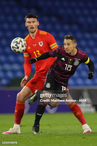 Kieffer Moore of Wales and Andreas Guardado of Mexico during the International Friendly match between Wales and Mexico at Cardiff City Stadium on...