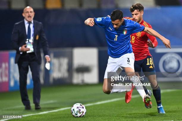 Italian's midfielder Gianluca Frabotta fights for the ball with Spain's forward Javier Puado during the 2021 UEFA European Under-21 Championship...