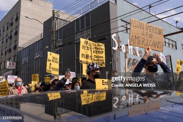 Members and supporters of the Asian-American community take part on the nationwide day of protests against anti-Asian violence in the Queens borough...