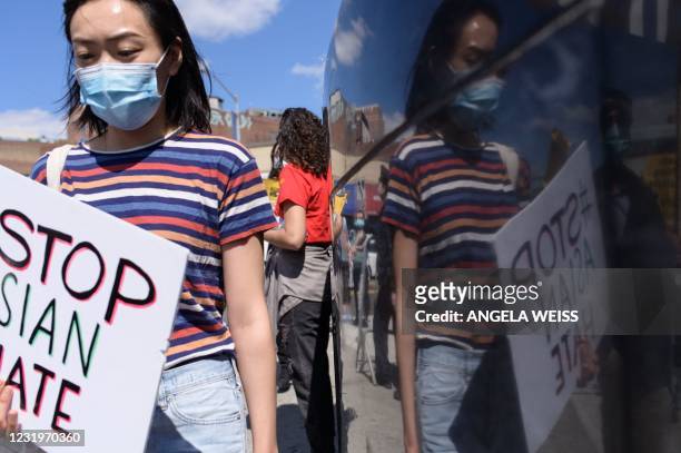 Members and supporters of the Asian-American community take part on the nationwide day of protests against anti-Asian violence in the Queens borough...