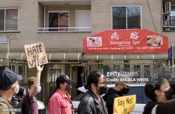 People watch as members and supporters of the Asian-American community take part in the nationwide day of protests against anti-Asian violence in the...