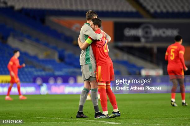 Wayne Hennessey hugs Chris Gunter of Wales prior to the International Friendly match between Wales and Mexico at the Cardiff City Stadium on March...