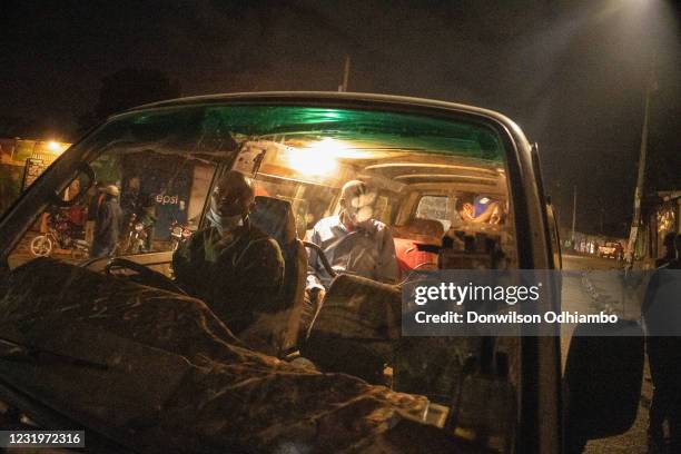 Buses from Nairobi City Center drop residents to their homes moments before curfew hours begin on March 27 in Nairobi, Kenya. Most residents from...