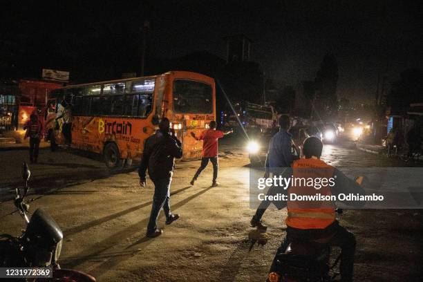 Buses from Nairobi City Center drop residents to their homes moments before curfew hours begin on March 27 in Nairobi, Kenya. Most residents from...