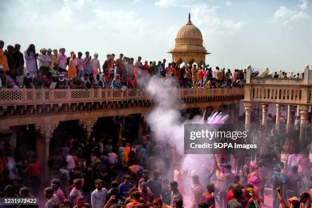 Hindu devotees play with colourful powders at Radharani Temple of Nandgaon during the Holi festival. Holi Festival of India is one of the biggest...