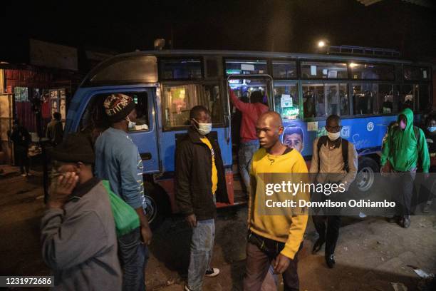 Buses from Nairobi City Center drop residents to their homes moments before curfew hours begin on March 27 in Nairobi, Kenya. Most residents from...