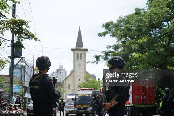 Police officer stand guard in the front of Makassar Cathedral Church after a suicide bomb attack in Makassar, South Sulawesi province, Indonesia on...