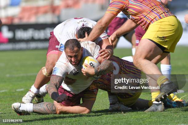 Beka Gigashvili of Georgia is tackled during the Rugby Europe International Championship round 4 match between Georgia and Romania at Mikheil Meskhi...