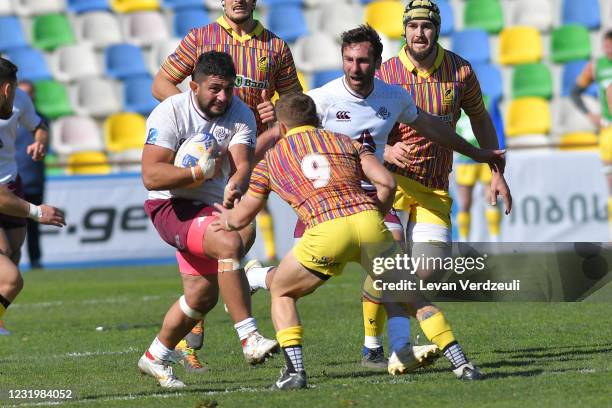 Giorgi Melikidze of Georgia runs with ball with Florin Surugiu of Romania against him during the Rugby Europe International Championship round 4...