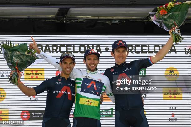 Team Ineos' British rider and winner Adam Yates poses on the podium with Team Ineos' second-placed Australian rider Richie Porte and Team Ineos'...