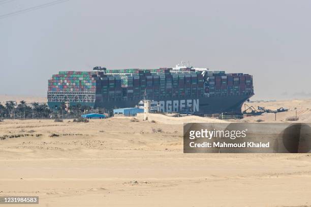 The container ship, the Ever Given, is seen at the Suez Canal on March 28, 2021 in Suez, Egypt. Work continues to free the Ever Given, a huge...