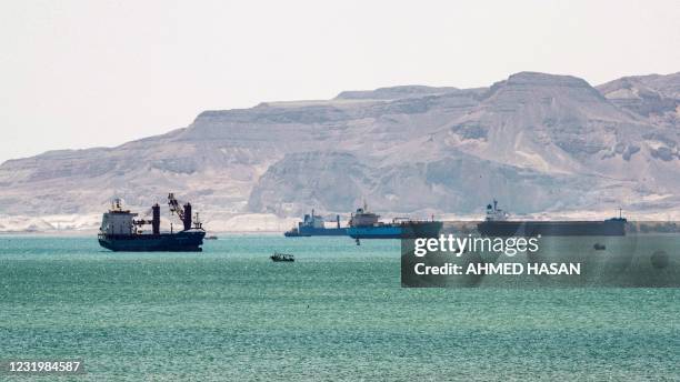 This picture taken on March 28, 2021 shows tanker and freight ships near the entrance of the Suez Canal, by Egypt's Red Sea port city of Suez.