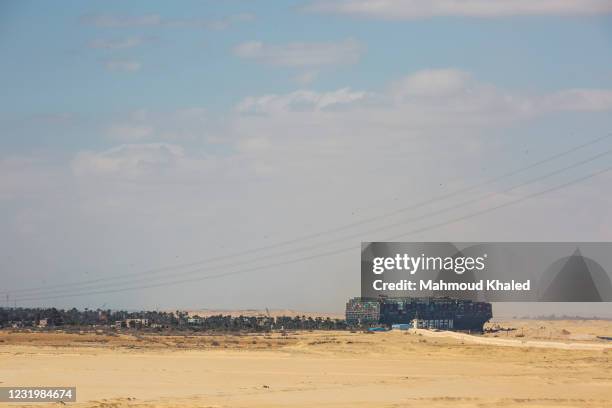 The container ship, the Ever Given, is seen at the Suez Canal on March 28, 2021 in Suez, Egypt. Work continues to free the Ever Given, a huge...