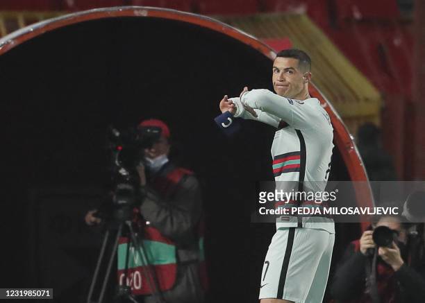 Portugal's forward Cristiano Ronaldo holds his captain armband moments before he threw it to the ground and left the pitch at the end of the FIFA...