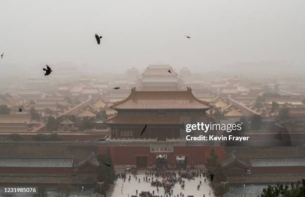Chinese tourists leave after visiting the Forbidden City during a sandstorm on March 28, 2021 in Beijing, China. China's capital and the northern...