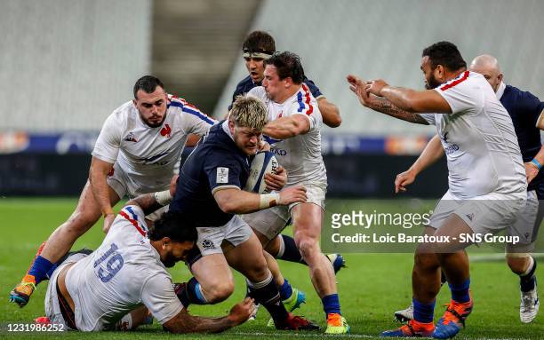 Scotlands Oli Kebble is tackled by Camille Chat during a Guinness Six Nations match between France and Scotland at the Stade de France, on March 26...