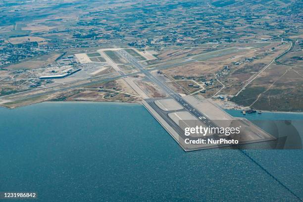 Aerial view from an aircraft window during a flight, of Thessaloniki International Airport Makedonia SKG LGTS. The new expansion of the airport's...