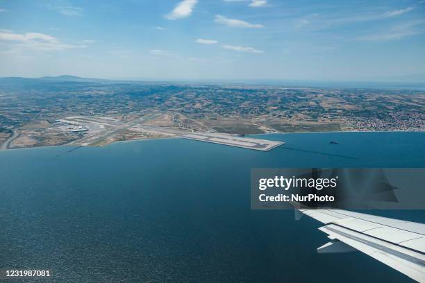 Aerial view from an aircraft window during a flight, of Thessaloniki International Airport Makedonia SKG LGTS. The new expansion of the airport's...