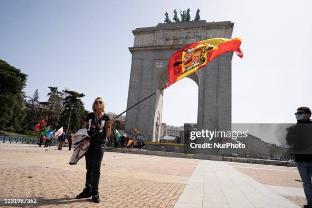 Spanish pre-constitutional flag waves in the air during a gathering of right-wing supporters at Arco de la Victoria commemorating the 82nd...