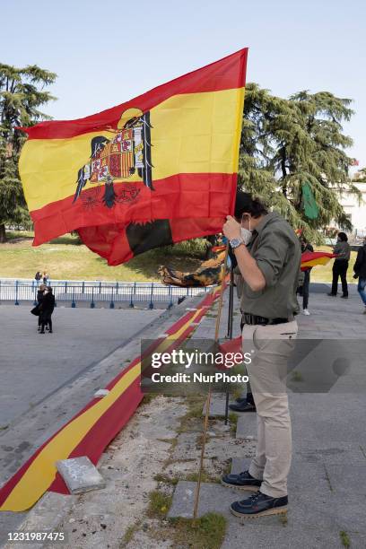 Spanish pre-constitutional flag waves in the air during a gathering of right-wing supporters at Arco de la Victoria commemorating the 82nd...