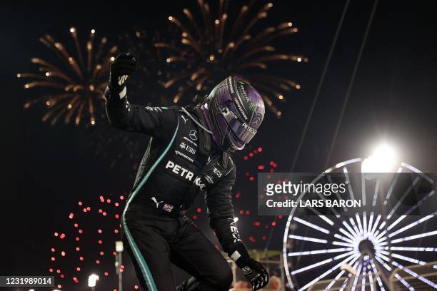 Mercedes' British driver Lewis Hamilton celebrates after winning the Bahrain Formula One Grand Prix at the Bahrain International Circuit in the city...