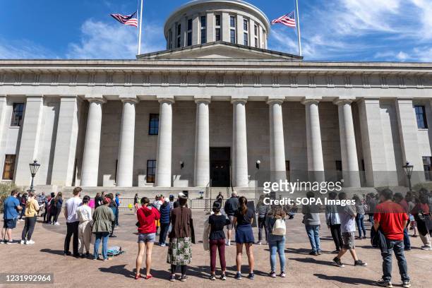Supporters of Asian Solidarity stand in front of the Ohio Statehouse during the rally. Filipino activist group AnakBayan partnered with Ohio...