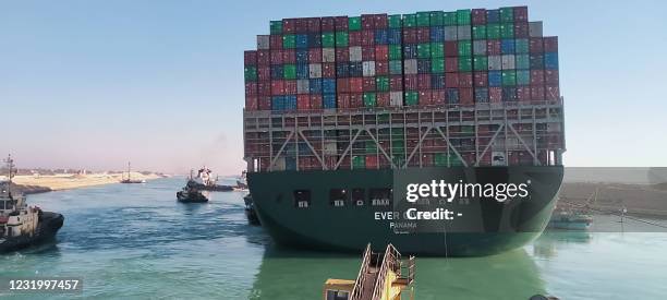 This picture taken on March 29, 2021 from a nearby tugboat in the Suez Canal shows a view of the Panama-flagged MV 'Ever Given' container ship as it...