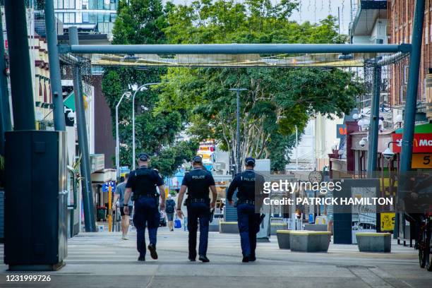 Police officers patrol the Valley Mall in Brisbane on March 29, 2021 as more than two million people in the city entered a three-day lockdown after a...