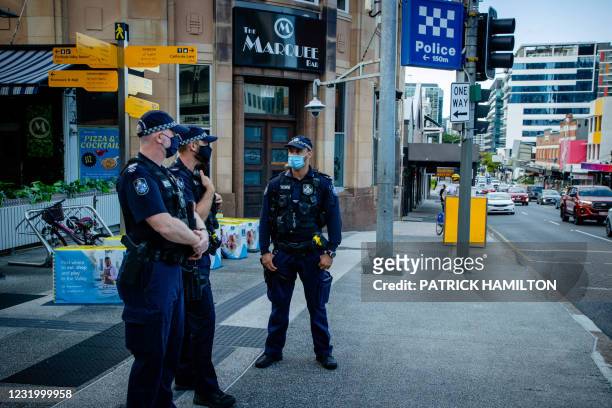 Police officers patrol the Valley Mall in Brisbane on March 29, 2021 as more than two million people in the city entered a three-day lockdown after a...
