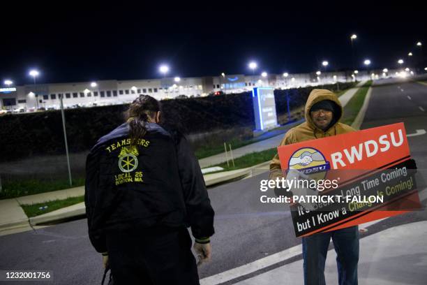 Union supporters distribute information before sunrise outside of the Amazon.com, Inc. BHM1 fulfillment center on March 29, 2021 in Bessemer,...