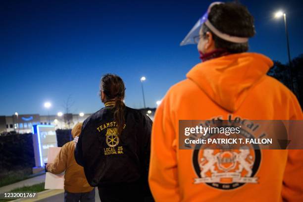 Union supporters distribute information before sunrise outside of the Amazon.com, Inc. BHM1 fulfillment center on March 29, 2021 in Bessemer,...